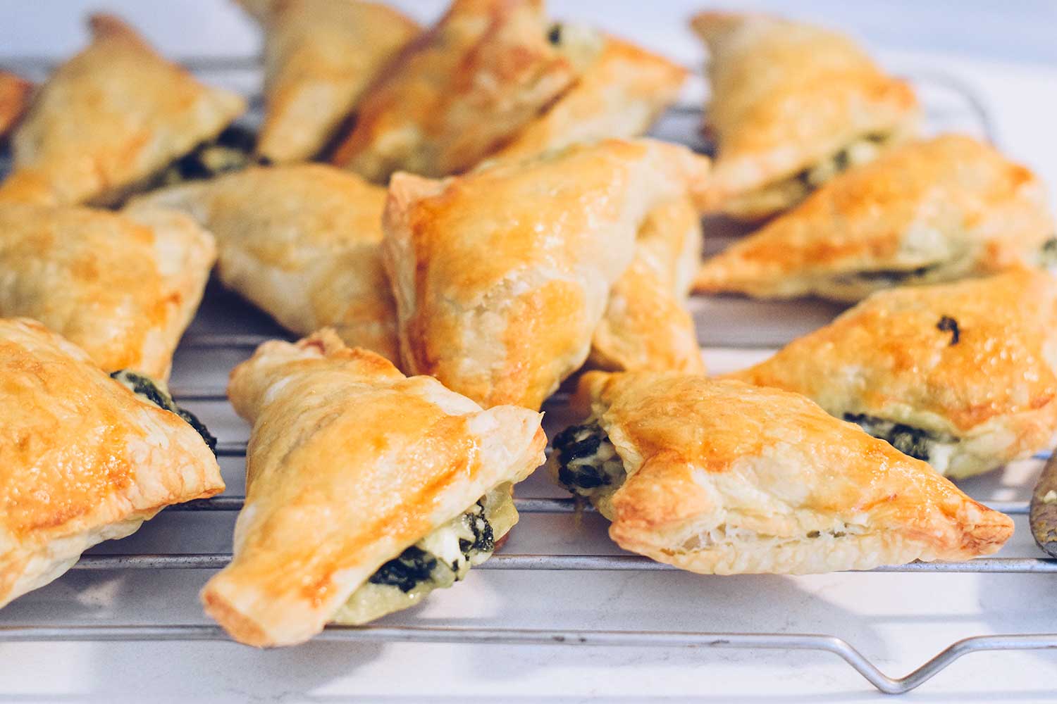 triangle pastries with feta and spinach cooling on 2021 08 30 04 05 31 utc
